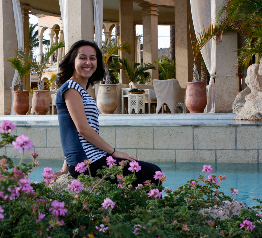 woman posing for a photo by a pool